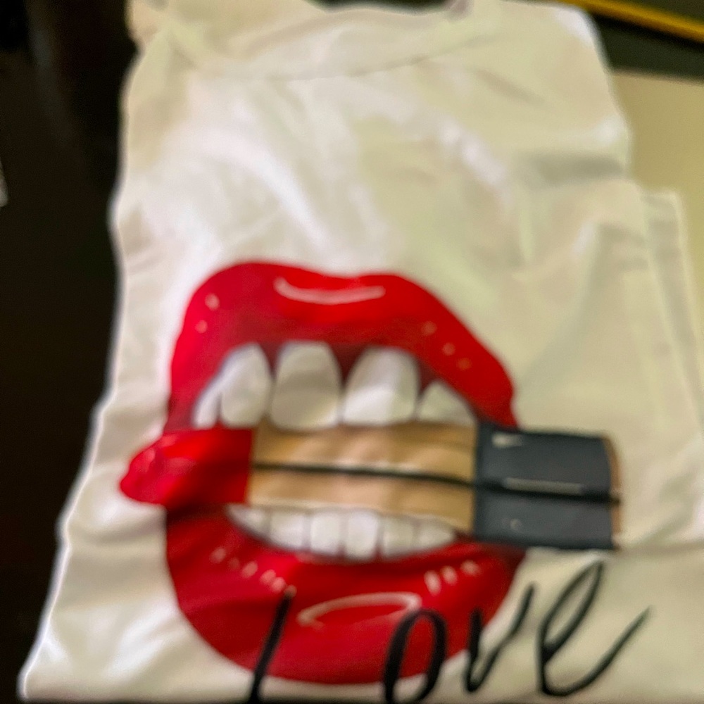 Large white T-shirt; runs small. Polyester/cotton. New in original package.